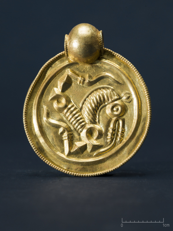 One of the nine gold pendants found by Erlend Bore on Rennesy, Stavanger municipality. © Annette Græsli Øvrelid, The Museum of Archaeology, University of Stavanger.