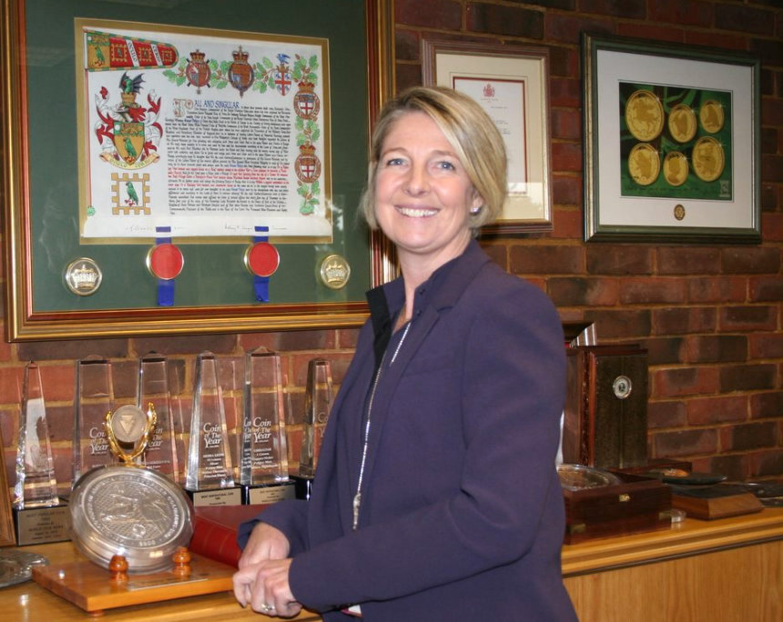 Taya Pobjoy. In the background trophies of the many achievements of the mint, such as the COTY awards. Photo: Michael Alexander, London Banknote and Monetary Research Centre.